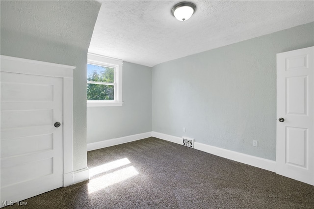1608 Pilgrim St, Akron, OH 44305 - additional living space featuring a textured ceiling, dark colored carpet, and baseboards