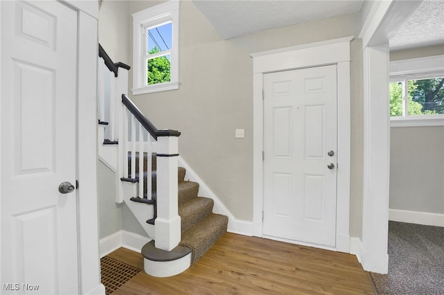 1608 Pilgrim St, Akron, OH 44305 - foyer with healthy amount of natural light, baseboards, wood finished floors, and stairway