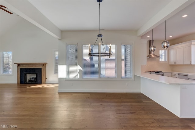 2540 Edgewood Trce, Pepper Pike, OH 44124 - kitchen with wall chimney exhaust hood, a chandelier, appliances with stainless steel finishes, light countertops, and white cabinets
