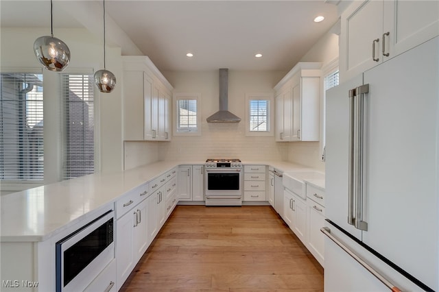 2540 Edgewood Trce, Pepper Pike, OH 44124 - kitchen featuring high end fridge, gas range oven, wall chimney exhaust hood, built in microwave, and a peninsula