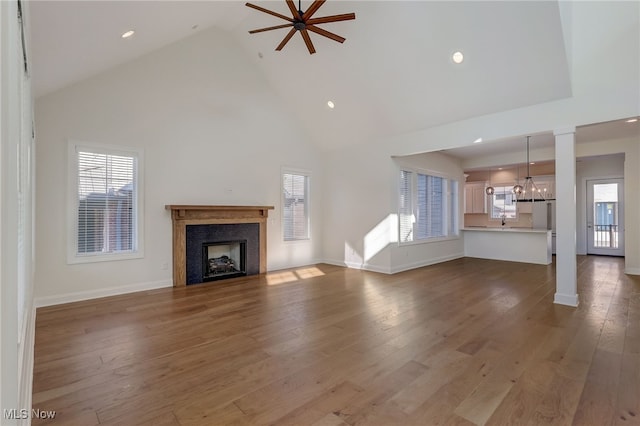2540 Edgewood Trce, Pepper Pike, OH 44124 - unfurnished living room with high vaulted ceiling, a chandelier, a fireplace, baseboards, and wood finished floors