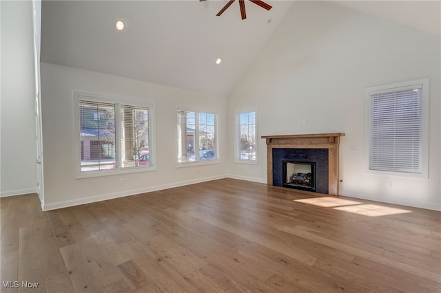 2540 Edgewood Trce, Pepper Pike, OH 44124 - unfurnished living room with high vaulted ceiling, healthy amount of natural light, a fireplace, wood finished floors, and a ceiling fan