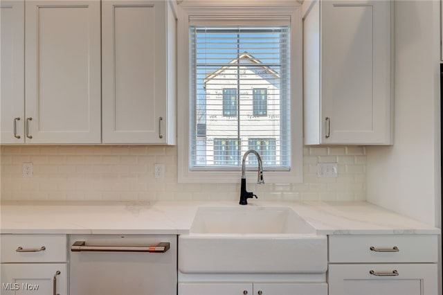 2540 Edgewood Trce, Pepper Pike, OH 44124 - kitchen featuring a sink, decorative backsplash, white cabinets, dishwashing machine, and light stone countertops