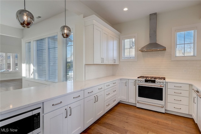 2540 Edgewood Trce, Pepper Pike, OH 44124 - kitchen featuring white range with gas stovetop, wall chimney range hood, stainless steel microwave, tasteful backsplash, and light countertops