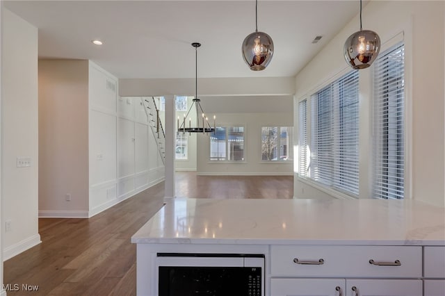 2540 Edgewood Trce, Pepper Pike, OH 44124 - kitchen with stainless steel microwave, wood finished floors, a chandelier, baseboards, and recessed lighting