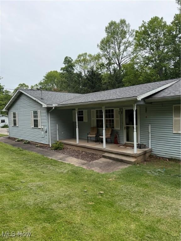 645 Arends Ridge Rd, Marietta, OH 45750 - back of property with a porch, a lawn, and roof with shingles