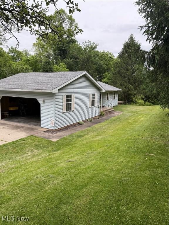 645 Arends Ridge Rd, Marietta, OH 45750 - view of property exterior featuring a shingled roof, a yard, and driveway