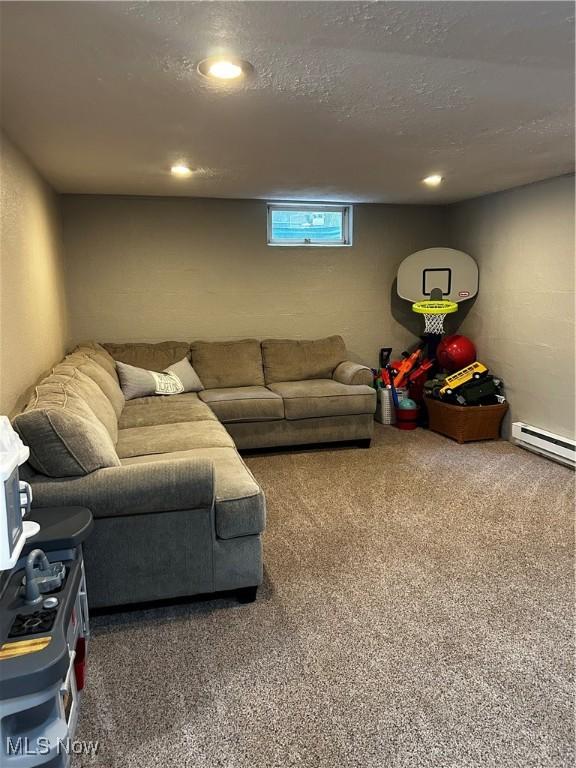 645 Arends Ridge Rd, Marietta, OH 45750 - carpeted living area with a baseboard heating unit