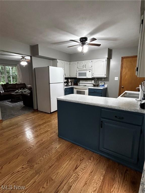 645 Arends Ridge Rd, Marietta, OH 45750 - kitchen featuring white appliances, a ceiling fan, a peninsula, and white cabinets