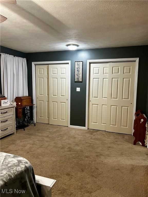 645 Arends Ridge Rd, Marietta, OH 45750 - carpeted bedroom featuring two closets and a textured ceiling