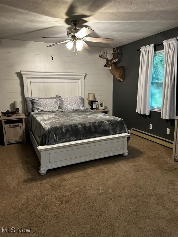 645 Arends Ridge Rd, Marietta, OH 45750 - carpeted bedroom featuring a baseboard heating unit, a textured ceiling, and a ceiling fan