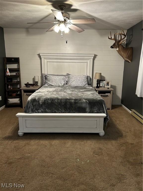 645 Arends Ridge Rd, Marietta, OH 45750 - bedroom with dark colored carpet, a textured ceiling, a ceiling fan, baseboards, and baseboard heating