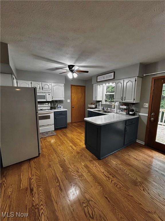 645 Arends Ridge Rd, Marietta, OH 45750 - kitchen featuring white electric range oven, freestanding refrigerator, a peninsula, a textured ceiling, and ceiling fan
