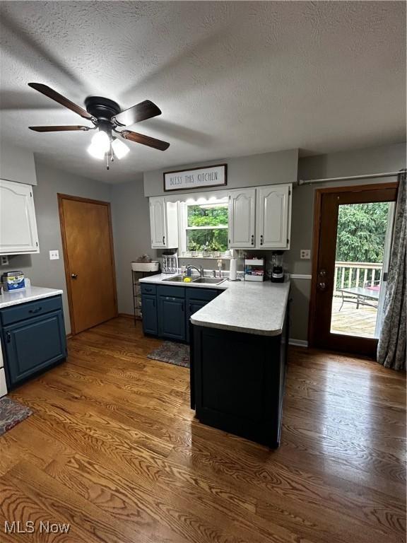 645 Arends Ridge Rd, Marietta, OH 45750 - kitchen with white cabinets, a peninsula, plenty of natural light, and a textured ceiling