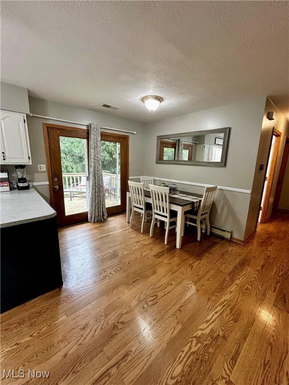 645 Arends Ridge Rd, Marietta, OH 45750 - dining area with a textured ceiling and light wood-style floors