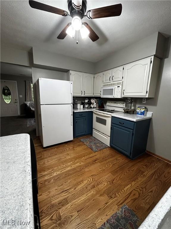 645 Arends Ridge Rd, Marietta, OH 45750 - kitchen with white appliances, blue cabinets, white cabinets, ceiling fan, and a textured ceiling