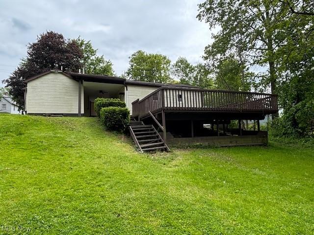 1445 E County Line Rd, Mineral Ridge, OH 44440 - back of property featuring a deck, a lawn, and stairway