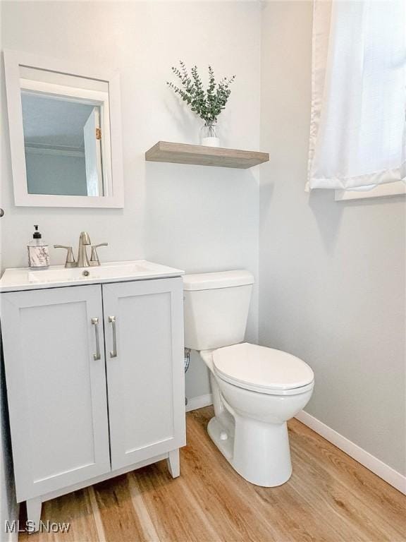 226 Cunningham Ln, Steubenville, OH 43952 - half bathroom with baseboards, wood finished floors, toilet, and vanity
