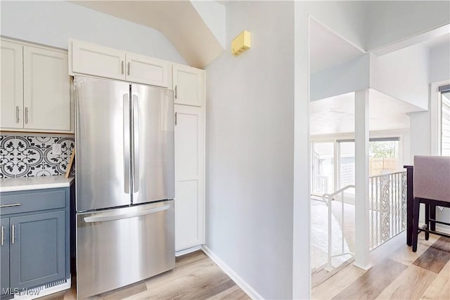 226 Cunningham Ln, Steubenville, OH 43952 - kitchen with freestanding refrigerator, light wood-style flooring, tasteful backsplash, light countertops, and vaulted ceiling