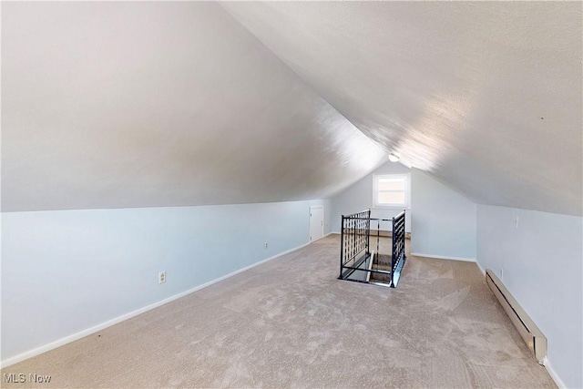 226 Cunningham Ln, Steubenville, OH 43952 - additional living space with baseboard heating, vaulted ceiling, light colored carpet, and baseboards