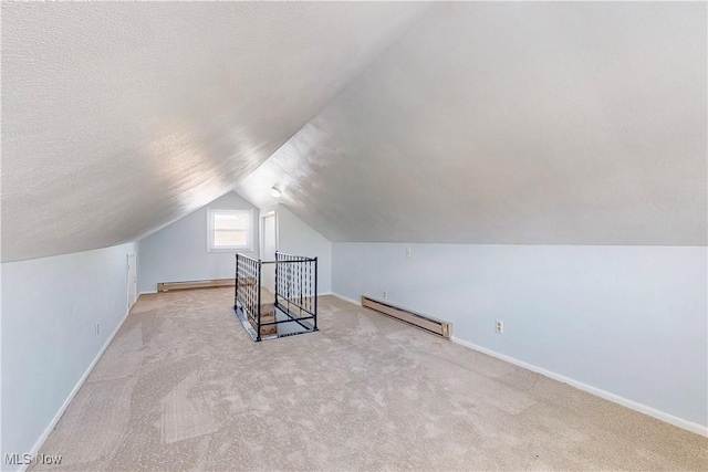 226 Cunningham Ln, Steubenville, OH 43952 - additional living space featuring baseboard heating, a baseboard heating unit, lofted ceiling, baseboards, and a textured ceiling