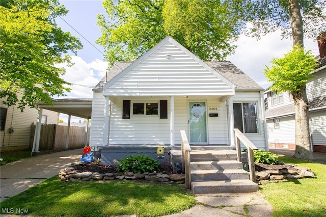 2464 Lyon Blvd, Poland, OH 44514 - bungalow featuring a shingled roof, concrete driveway, and an attached carport