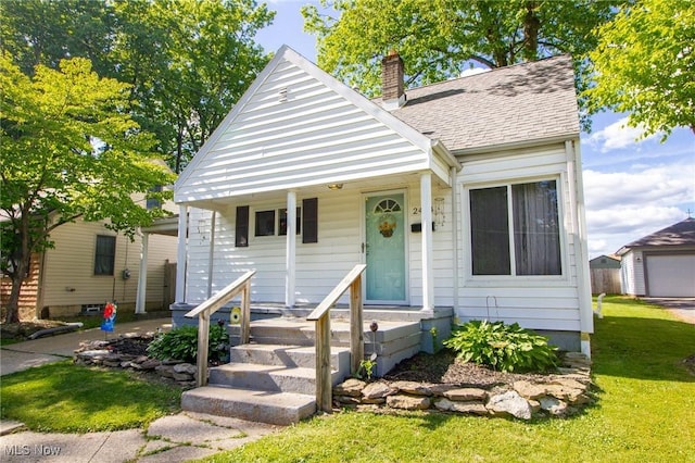 2464 Lyon Blvd, Poland, OH 44514 - bungalow featuring a chimney, a front yard, and roof with shingles
