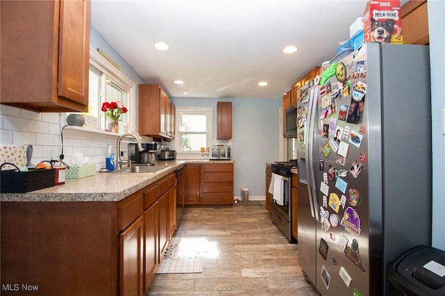 2464 Lyon Blvd, Poland, OH 44514 - kitchen featuring appliances with stainless steel finishes, a sink, brown cabinetry, recessed lighting, and decorative backsplash