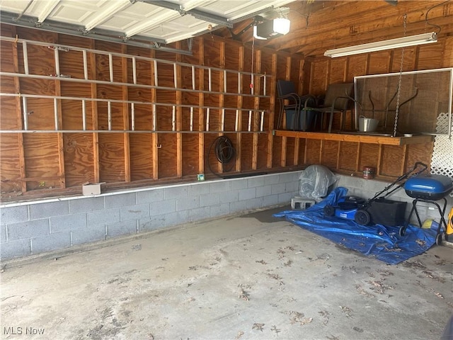 12704 Oak Park Blvd, Garfield Heights, OH 44125 - garage featuring a garage door opener and concrete block wall