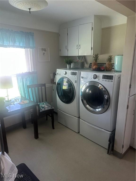 12704 Oak Park Blvd, Garfield Heights, OH 44125 - washroom featuring separate washer and dryer, light carpet, and cabinet space