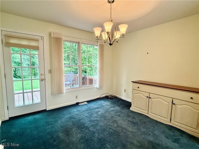 5228 Nashua Dr, Austintown, OH 44515 - unfurnished dining area with dark colored carpet, a chandelier, and baseboards