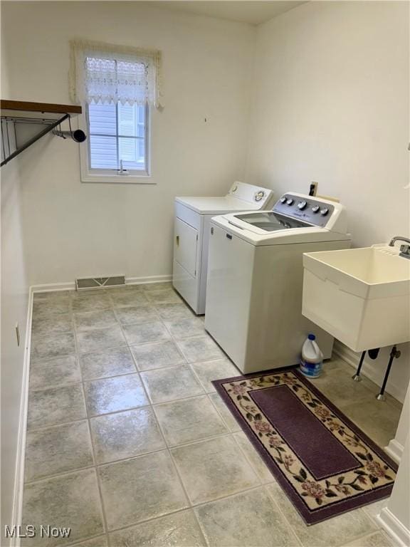 5228 Nashua Dr, Austintown, OH 44515 - laundry area featuring washing machine and dryer, light tile patterned flooring, and baseboards