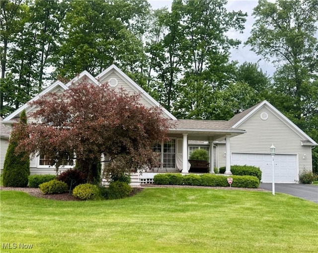 5228 Nashua Dr, Austintown, OH 44515 - view of front of property featuring driveway, covered porch, a front lawn, and a garage