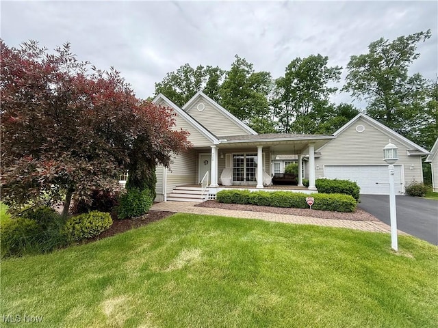 5228 Nashua Dr, Austintown, OH 44515 - view of front of home with asphalt driveway, a garage, a porch, and a front yard
