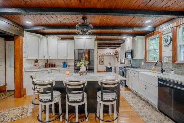 2953 State Route 225, Diamond, OH 44412 - kitchen with appliances with stainless steel finishes, wooden ceiling with exposed beams, tasteful backsplash, and light wood-style flooring