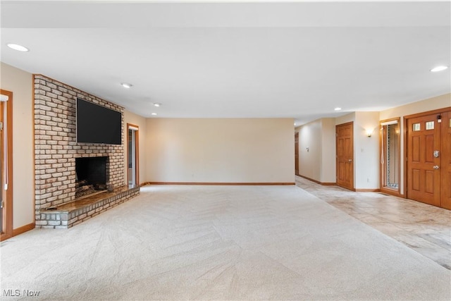 3751 Muirfield Dr, Uniontown, OH 44685 - unfurnished living room featuring light colored carpet, recessed lighting, a brick fireplace, and baseboards