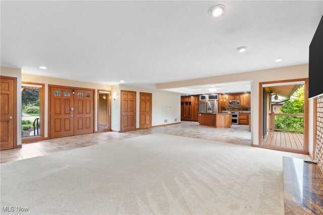 3751 Muirfield Dr, Uniontown, OH 44685 - unfurnished living room with light carpet, plenty of natural light, recessed lighting, and baseboards