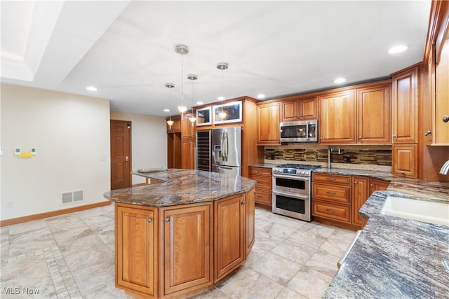 3751 Muirfield Dr, Uniontown, OH 44685 - kitchen featuring stainless steel appliances, a sink, recessed lighting, a center island, and dark stone countertops