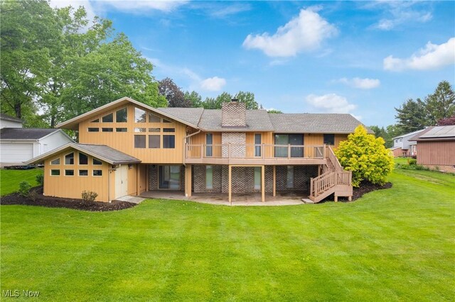 3751 Muirfield Dr, Uniontown, OH 44685 - rear view of property with a chimney, a deck, a lawn, stairs, and a patio area
