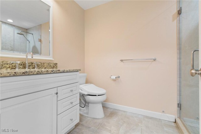 3751 Muirfield Dr, Uniontown, OH 44685 - full bathroom featuring toilet, vanity, a stall shower, and baseboards