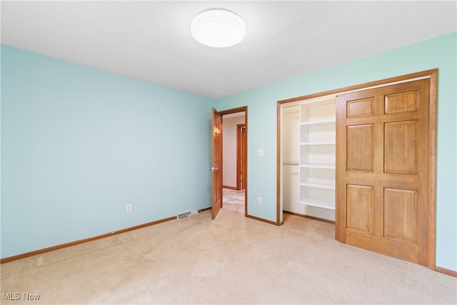 3751 Muirfield Dr, Uniontown, OH 44685 - unfurnished bedroom featuring light colored carpet, baseboards, and a closet