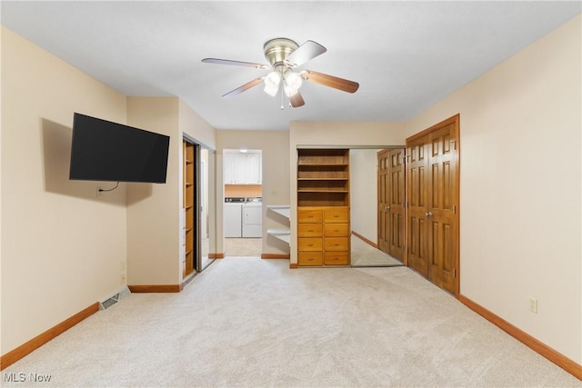 3751 Muirfield Dr, Uniontown, OH 44685 - unfurnished bedroom featuring washer and clothes dryer, light carpet, baseboards, and a ceiling fan