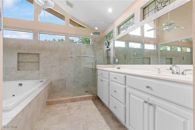 3751 Muirfield Dr, Uniontown, OH 44685 - full bathroom featuring ceiling fan, a shower stall, double vanity, a whirlpool tub, and lofted ceiling