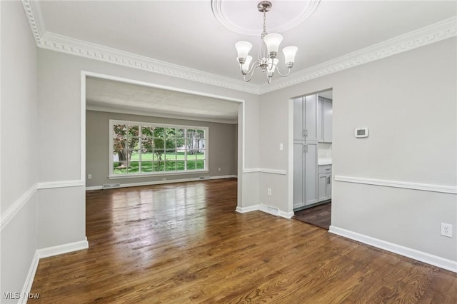 7558 E Parkside Dr, Boardman, OH 44512 - empty room featuring a chandelier, wood finished floors, ornamental molding, and baseboards