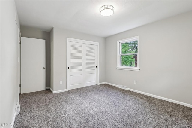 7558 E Parkside Dr, Boardman, OH 44512 - unfurnished bedroom featuring carpet floors, a closet, and baseboards