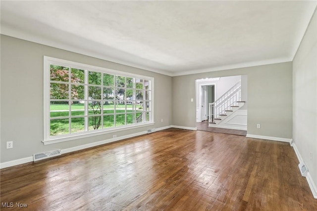 7558 E Parkside Dr, Boardman, OH 44512 - empty room featuring stairway, wood finished floors, and baseboards