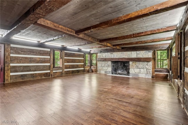 7558 E Parkside Dr, Boardman, OH 44512 - unfurnished living room with hardwood / wood-style floors, a stone fireplace, and wood walls