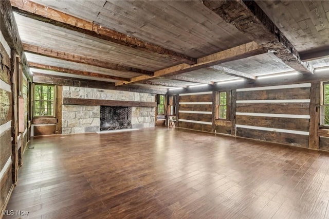 7558 E Parkside Dr, Boardman, OH 44512 - unfurnished living room featuring wood finished floors, a fireplace, wooden walls, and healthy amount of natural light
