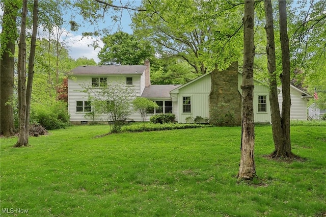 7558 E Parkside Dr, Boardman, OH 44512 - rear view of property featuring a chimney and a yard