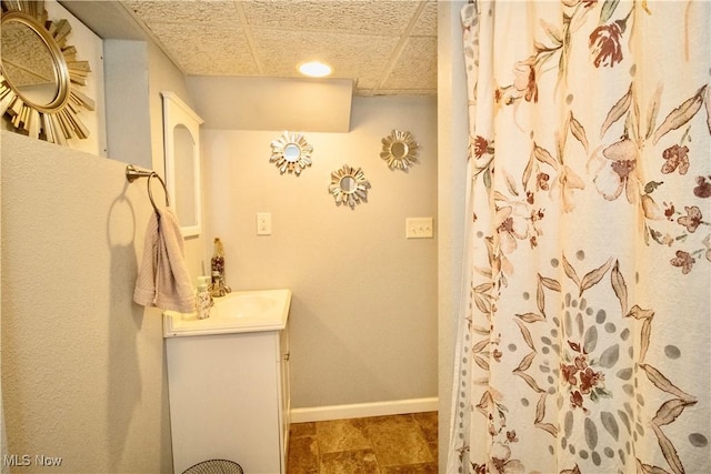6892 Glenwood Ave, Youngstown, OH 44512 - full bath with vanity, baseboards, a shower with curtain, and a drop ceiling